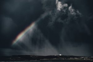 Rainbow against dark clouds