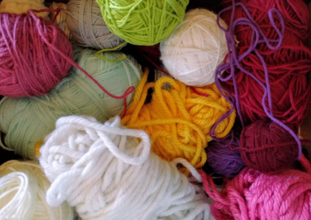 A pile of yarn balls in different colors