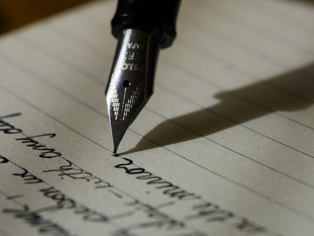 A fountain pen writing on a piece of paper