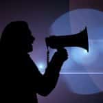 silhouette of a woman speaking into a microphone