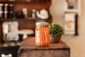 Bottled carrots on a wooden table