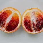 Two halves of a blood orange side by side