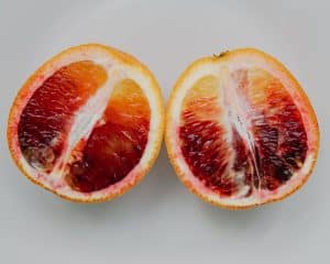 Two halves of a blood orange side by side