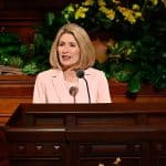 President Camille N. Johnson speaking at the pulpit in General Conference