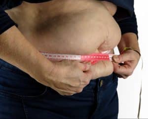 Measuring tape around stomach