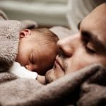 baby resting on father