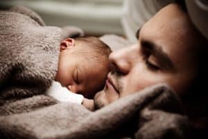 baby resting on father