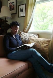 Woman studying a book with light from a window