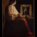 woman sitting in front of mirror