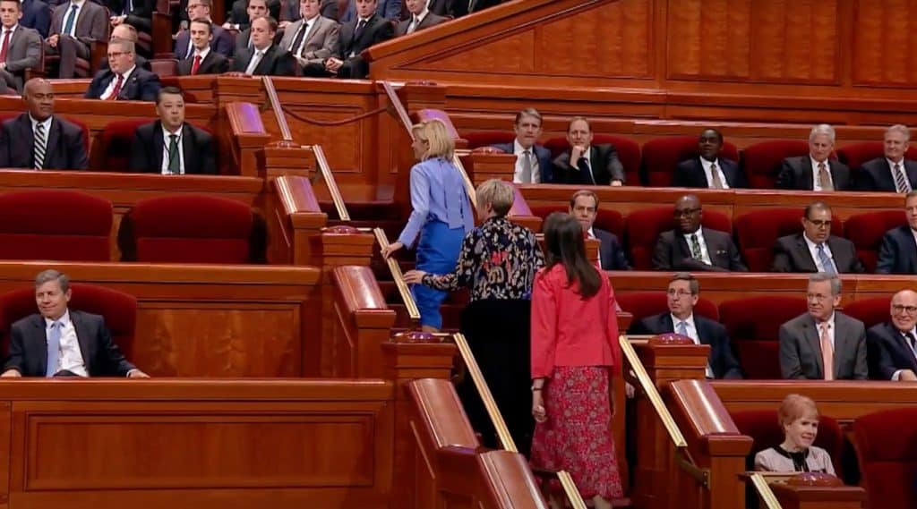 Three of the LDS Church's nine woman leaders, Young Women First Counselor Sister Tamara W. Runia, President Emily Belle Freeman and Second Counselor Sister Andrea Muñoz Spannaus, go to the stand at General Conference, April 1, 2023.