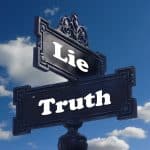 a street sign with cross streets labelled "lie" and "truth"