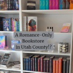 Bookshelf with romance novels and book related merchandise from Lagg Bookstore in Lehi, Utah