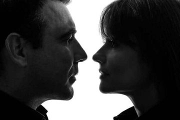 one caucasian couple woman man face to face in silhouette studio   on white background