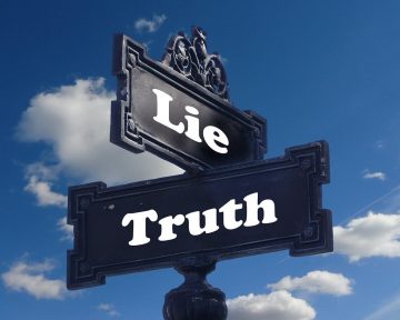 a street sign with cross streets labelled "lie" and "truth"